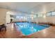 Spacious indoor pool area with bright lighting, tile flooring, and large windows at 937 N Clarkson St # 206, Denver, CO 80218