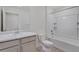 Well lit bathroom features a single sink vanity, tub and shower combo and neutral colors at 286 Chardon Ave, Brighton, CO 80601