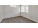Serene bedroom features stylish hardwood floors, ample natural light, and fresh, white walls at 286 Chardon Ave, Brighton, CO 80601