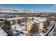 Winter aerial view of multi-Gathering homes featuring snow covered roofs, grounds, and mountain views at 3035 Oneal Pkwy # 36T, Boulder, CO 80301