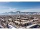 Overhead view showcasing the neighborhood, buildings and snow-covered mountains in the distance at 3035 Oneal Pkwy # 36T, Boulder, CO 80301