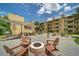 Relaxing courtyard featuring a fire pit, picnic tables, and comfortable seating with beautiful landscaping and sunny skies at 3035 Oneal Pkwy # 36T, Boulder, CO 80301