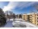 Winter view of building exterior featuring snow covered grounds and fenced in area under bright sunny skies at 3035 Oneal Pkwy # 36T, Boulder, CO 80301
