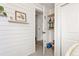 Bright hallway features shiplap walls, shelving, and a peek into a well-organized closet with natural wood shelves at 3035 Oneal Pkwy # 36T, Boulder, CO 80301