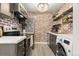 Updated kitchen featuring brick accent wall, stainless steel appliances, and modern cabinetry at 3035 Oneal Pkwy # 36T, Boulder, CO 80301