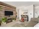 Modern living room with wood accent wall, cozy fireplace, and comfortable seating for relaxation and entertainment at 3035 Oneal Pkwy # 36T, Boulder, CO 80301