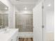 Bathroom featuring glass-enclosed shower, wood-look flooring and access to adjoining room at 22435 E 7Th Pl, Aurora, CO 80018
