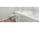 A modern bathroom with a double sink vanity, sleek fixtures, and wood-style flooring offers convenience at 22435 E 7Th Pl, Aurora, CO 80018