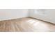 Cozy bedroom featuring light wood flooring, white trim, and window with blinds at 22435 E 7Th Pl, Aurora, CO 80018