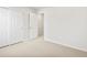 A bright, carpeted bedroom with a closet offers ample space, natural light, and easy access to the hallway at 22435 E 7Th Pl, Aurora, CO 80018