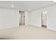 Bright bedroom featuring neutral carpet, white walls, and access to ensuite bathroom and walk-in closet at 22435 E 7Th Pl, Aurora, CO 80018