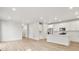 Bright kitchen features white cabinets, stainless appliances, and island, seamlessly connecting to living space at 22435 E 7Th Pl, Aurora, CO 80018