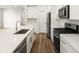 Modern kitchen with stainless appliances, white cabinetry, and a large center island at 22435 E 7Th Pl, Aurora, CO 80018