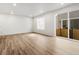 Bright living room featuring sliding glass door access to patio, and wood-look floors, creating a welcoming space at 22435 E 7Th Pl, Aurora, CO 80018