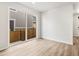 Bright living room features a sliding glass door to a balcony and light wood flooring at 22435 E 7Th Pl, Aurora, CO 80018