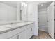 Bright bathroom with double sinks, white vanity, and a shower/tub combo in the adjacent room at 4730 Hatcher Dr, Brighton, CO 80601