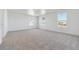 Large bedroom with three windows offering abundant natural light, and neutral carpet at 4730 Hatcher Dr, Brighton, CO 80601