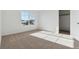 Bright bedroom with a large window, neutral carpet, and view of neighborhood at 4730 Hatcher Dr, Brighton, CO 80601