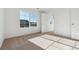 Bright, airy bedroom features large windows, neutral carpeting, and white trim, offering a serene and inviting space at 4730 Hatcher Dr, Brighton, CO 80601