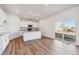 Modern kitchen features an island with granite countertops, stainless steel appliances, and wood-style flooring at 4730 Hatcher Dr, Brighton, CO 80601
