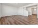 Spacious living room with wood-style flooring and white walls with an open staircase at 4730 Hatcher Dr, Brighton, CO 80601