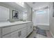 Well lit bathroom featuring double vanity sinks and a bath tub at 8470 Arriba Dr, Littleton, CO 80125