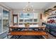 Bright dining room with a large table and chairs, and a sliding door to the outside at 8470 Arriba Dr, Littleton, CO 80125