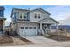 Charming two-story home featuring stone accents, a covered porch, and a two-car garage at 8470 Arriba Dr, Littleton, CO 80125