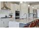 Close up of the modern kitchen featuring stainless appliances and a granite island at 8470 Arriba Dr, Littleton, CO 80125