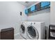 Well-lit laundry room with modern appliances and blue storage baskets at 8470 Arriba Dr, Littleton, CO 80125