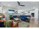 Comfortable living room flowing into kitchen with a large sofa, stylish decor, and hardwood floors at 8470 Arriba Dr, Littleton, CO 80125