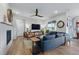 Well-lit living room featuring a fireplace, hardwood floors, and contemporary decor at 8470 Arriba Dr, Littleton, CO 80125