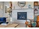 Living room showcasing a modern fireplace, built-in shelving, and a comfortable armchair at 8470 Arriba Dr, Littleton, CO 80125