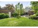 Expansive backyard featuring a patio with outdoor dining set and lush green lawn at 628 Cherry St, Denver, CO 80220