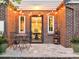 Exterior patio featuring bistro set and brick siding with string lights at 628 Cherry St, Denver, CO 80220