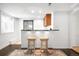 Entertaining bar area featuring two stools, a countertop, and wooden cabinets at 628 Cherry St, Denver, CO 80220