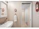 Well-lit bathroom featuring sink, mirror, and doorway to another room at 628 Cherry St, Denver, CO 80220