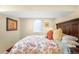 Bedroom features a large bed with floral comforter and soft color palette at 628 Cherry St, Denver, CO 80220
