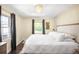 Bright bedroom boasts natural light, hardwood floors, and a large bed with white linens at 628 Cherry St, Denver, CO 80220