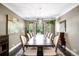 Elegant dining room with large wooden table, stylish chandelier, and ample natural light, perfect for entertaining at 628 Cherry St, Denver, CO 80220