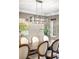 Close up of elegant dining room, showcasing a large wooden table, stylish chandelier, and seating for eight at 628 Cherry St, Denver, CO 80220