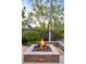 Outdoor brick fire pit area with lava rocks and a wooden fence at 628 Cherry St, Denver, CO 80220