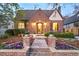 Inviting brick home with stone walkway, garden and exterior lighting at 628 Cherry St, Denver, CO 80220
