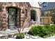 Brick home featuring arched window, walkway, manicured landscaping and charming exterior details at 628 Cherry St, Denver, CO 80220