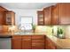 Well-maintained kitchen featuring wooden cabinetry, tile backsplash, and ample counter space, providing functionality and charm at 628 Cherry St, Denver, CO 80220