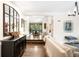 Elegant living room with hardwood floors, neutral walls, and open dining area, creating a bright and airy space at 628 Cherry St, Denver, CO 80220