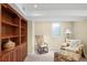 Cozy living room features built-in shelving, comfy chair, and plenty of natural light at 628 Cherry St, Denver, CO 80220