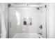 Updated shower boasts tile surround, glass doors, and a built-in niche for toiletries at 628 Cherry St, Denver, CO 80220