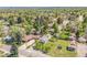 Beautiful aerial view of the property showcasing the well-maintained lawn, mature trees, and surrounding neighborhood at 7340 W 32Nd Ave, Wheat Ridge, CO 80033