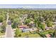 This aerial perspective captures the property within a vibrant neighborhood, featuring mature trees and distant city views at 7340 W 32Nd Ave, Wheat Ridge, CO 80033